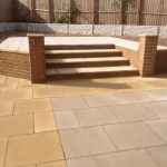 Landscaping and paving steps with small surrounding wall